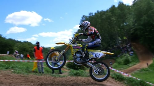 Motorcyclists Race on a Motocross Dirt Track