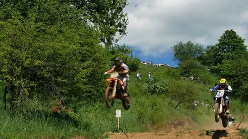 Motocross Racers Jumping Dirt Bikes on Outdoor Course