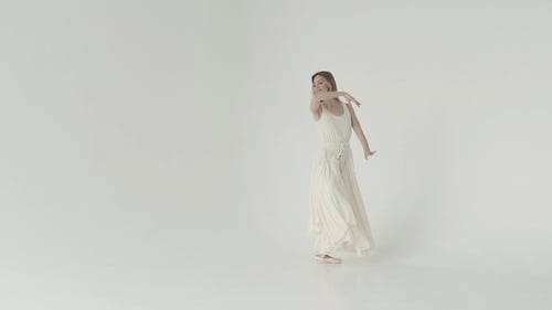 Elegant Ballerina Dancing Gracefully in White Dress