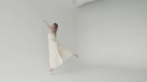 Elegant Woman Ballet Dancing in White Studio