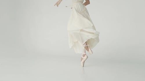 Graceful Ballerina Twirling in White Studio