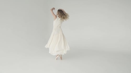 Blonde Woman Dancing Ballet in White Studio