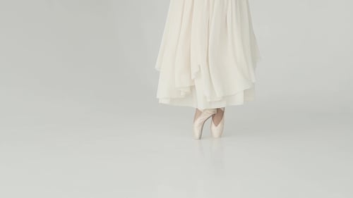 Ballet Dancer Performing in White Studio