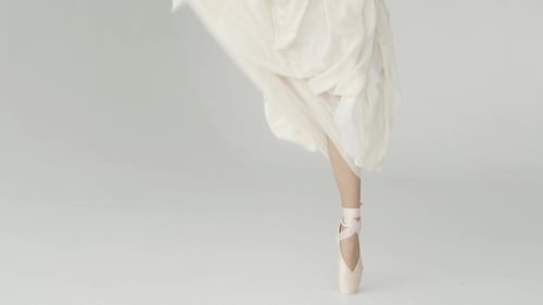 Ballet Dancer in White Dress Dancing on Pointe
