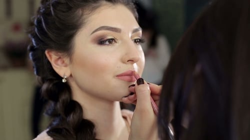 Applying Lip Liner to Glamorous Woman