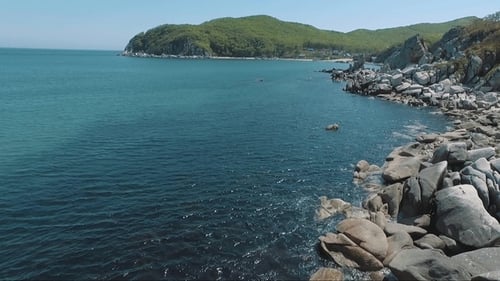 Aerial Drone Flight Around the Rocks in Sea on Tropical Coast