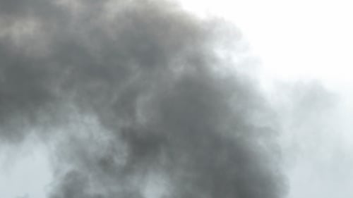 Rising Dark Smoke on Grey Background