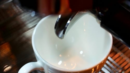 Espresso Pouring into White Mug from Machine