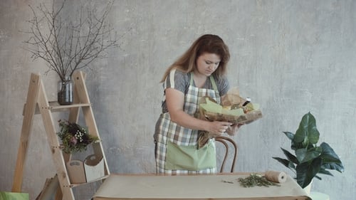 Woman Decorating Edible Arrangement with Herbs