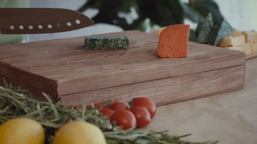 Cheese Being Cut On Wooden Cutting Board