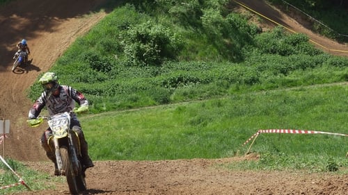 Motocross Racers Jumping on Rural Dirt Track