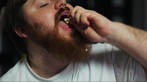 Man Eating Snack in Close Up