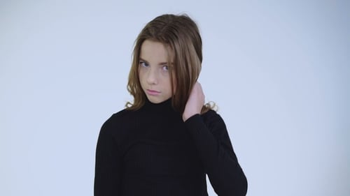 Stylish Attractive Girl with Long Hair Poses at Camera