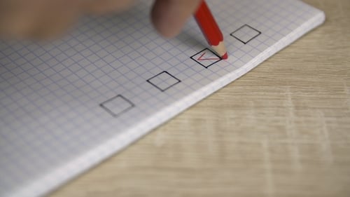 Red Checkmark Putting Into Check List in Copybook