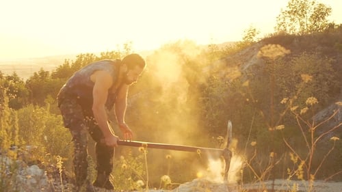 The Brutal Man Beating the Stone with Hammer on the Rock. Slowly