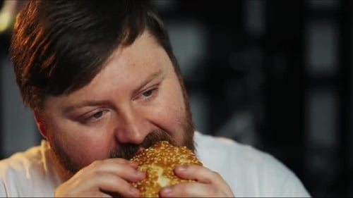 Man Enjoys a Burger in Close Up Shot