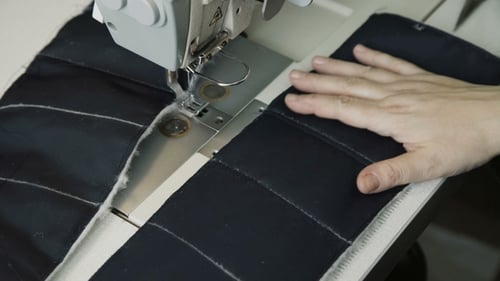 Woman Uses Sewing Machine in Workshop