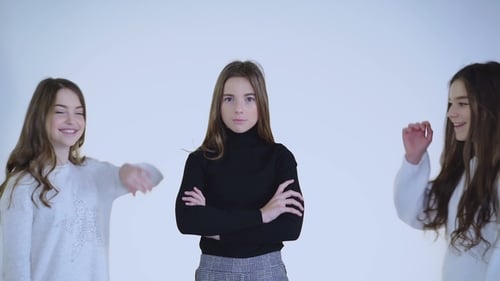 Three Attractive Girls Stand with Crossed Hands Then in Embraces Look