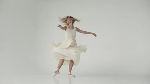 Elegant Woman Ballerina Dancing in White Dress