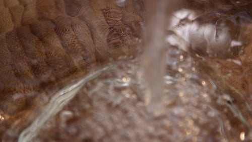Water Pouring Into Clear Glass Bowl Close Up