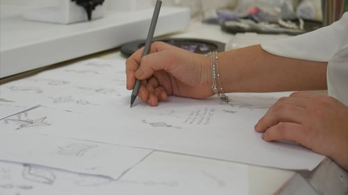 Jewelry Designer s Hand Sketching Out Designs in Studio