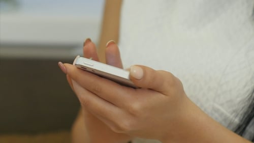 Woman Using Smartphone Device in Close Up View