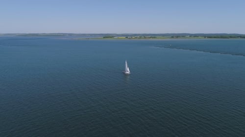 Sailboat on the Blue Ocean on a Sunny Day