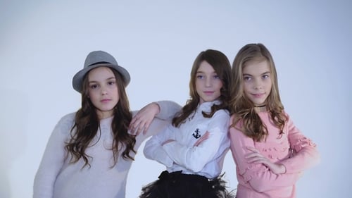 Three Smiling Girls Posing Together in Studio