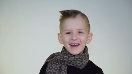 Portrait of a Smiling Child Wearing a Scarf