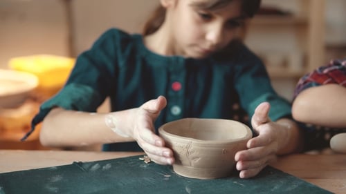 Girl Creating Pottery Bowl Indoors