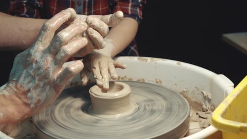 Pottery Class With Adult and Child Shaping Clay