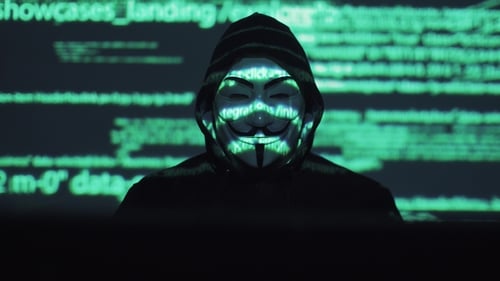 Theft of Personal Data on the Network. Robber in the Mask and Hood Against the Background of the