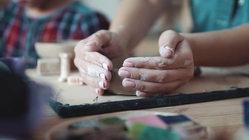Hands Shaping Clay into a Small Bowl