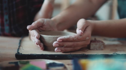 Artist Shaping Clay into Pottery Bowl