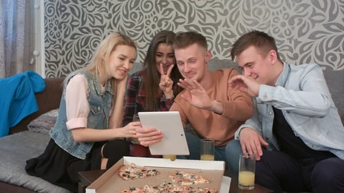 Young Adults Video Chatting and Eating Pizza