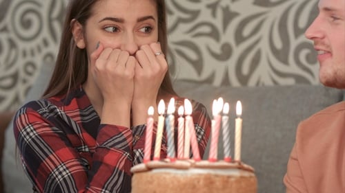 Smiling Woman Celebrates Birthday with Friends at Home