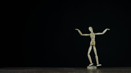 Wooden Figure Dummy in Studio on Black Background Rotating and Showing i Dont Know