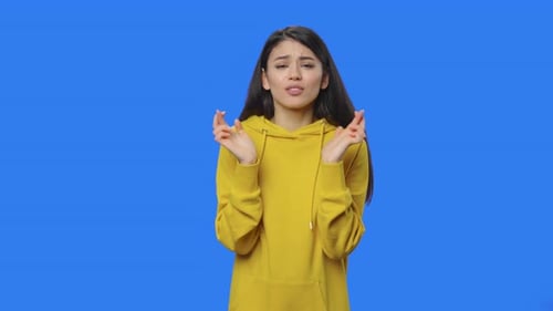 Excited Woman Celebrating Victory on Blue Background