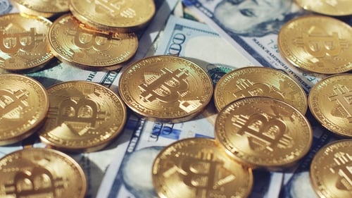 Close Up Gold Bitcoin Coins on Dollar Bills