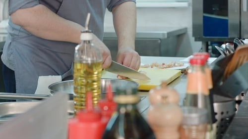 Chef Chopping Garlic in a Commercial Kitchen
