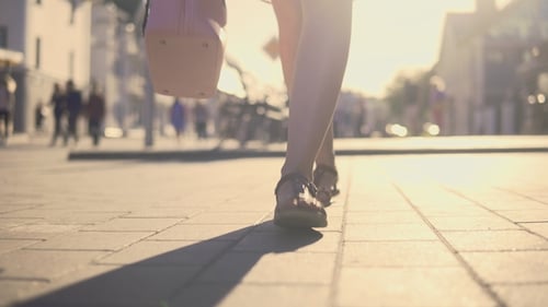 Legs. The Girl Is Walking Around the City.