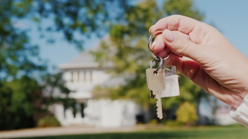 The Hand Holds the Key To the House. Rent and Purchase of Housing Concept