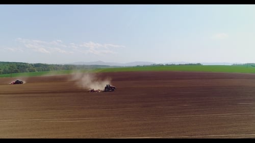 Aerial of Tractor on Harvest Field Ploughing Agricultural Field