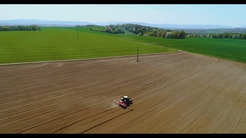 Tractor Working in Beautiful Spacious Agricultural Field