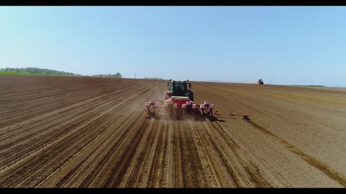 Aerial of Tractor on Harvest Field Ploughing Agricultural Field