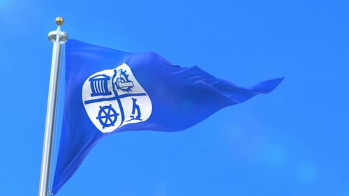 Blue Flag Waving with Emblem Against Clear Sky