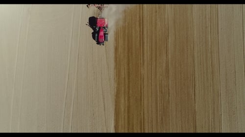 Aerial of Tractor on Harvest Field Ploughing Agricultural Field