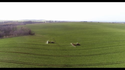 Tractor Spray Fertilize on Field with Chemicals in Agriculture Field