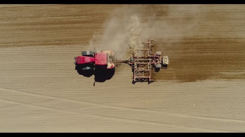 Aerial of Tractor on Harvest Field Ploughing Agricultural Field