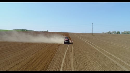 Aerial of Tractor on Harvest Field Ploughing Agricultural Field